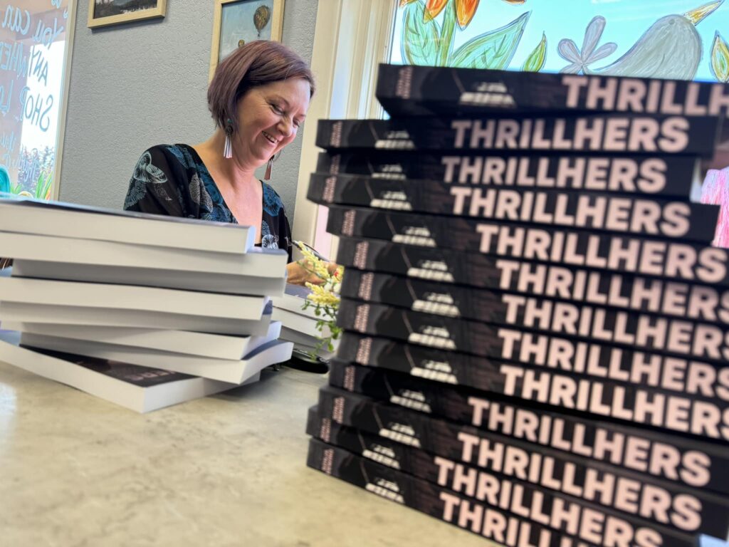 Sonja Dewing signing books at an author event